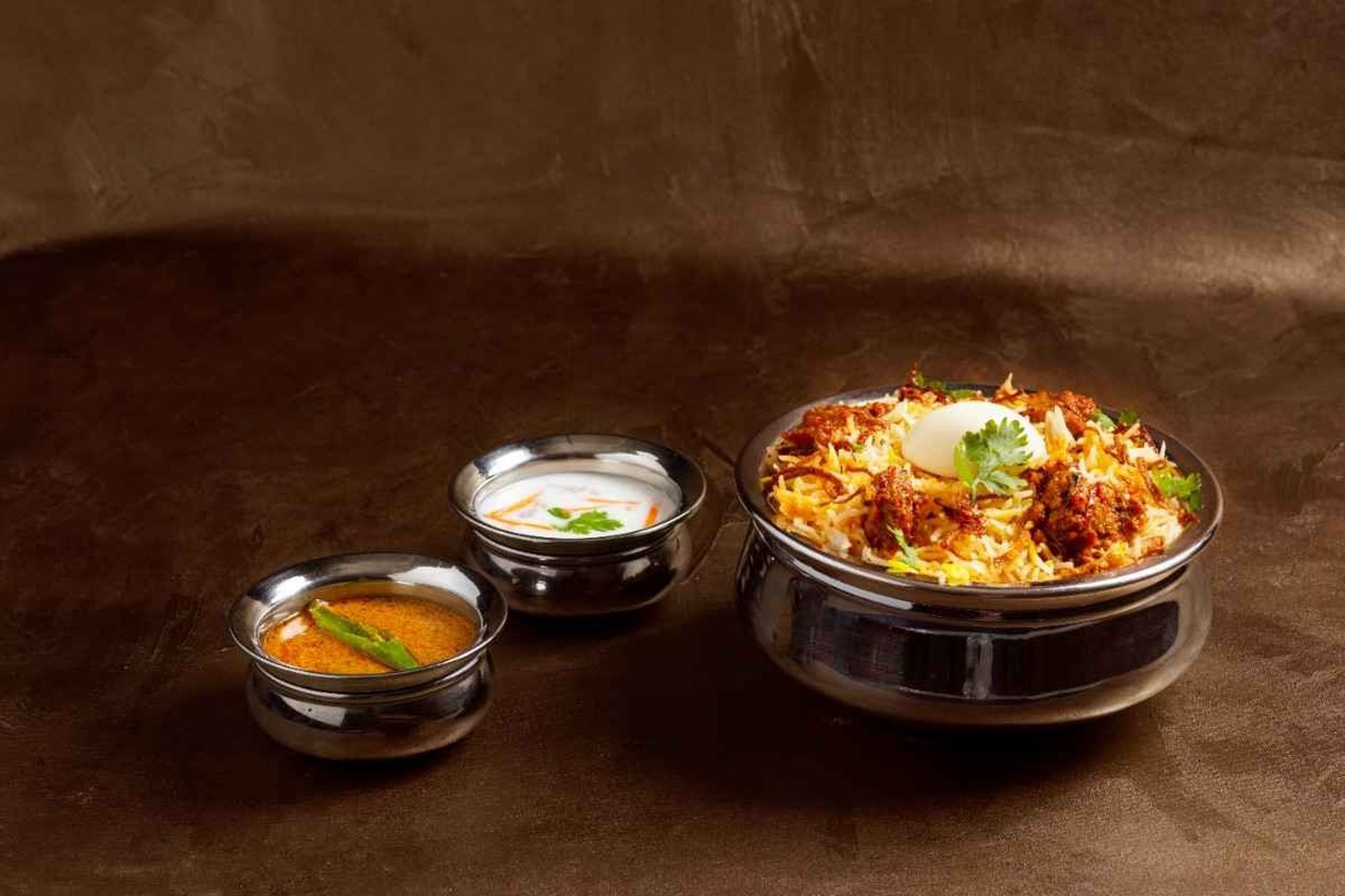 Hyderabadi dum biryani with raita and salan
